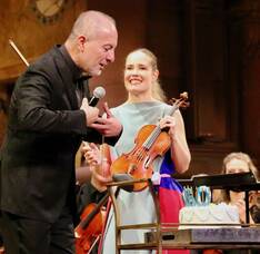 Carousel image e76751d65711004286bd 1 14 25 rossen milanov blew out candles on a birthday cake with leila josefowicz alongside