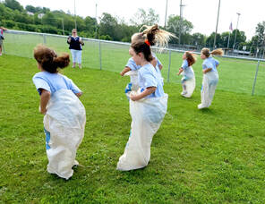 Carousel image 954b634f5086f2ce27db 6 20 lions kids day girls sack race hair