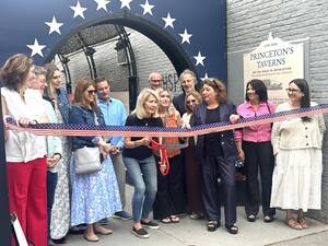 Carousel image bdb373f0a4e6e30a3e02 6 4 26 ribbon cutting at dophm alley with sheila nall an experience princeton voluntee wielding the scissors