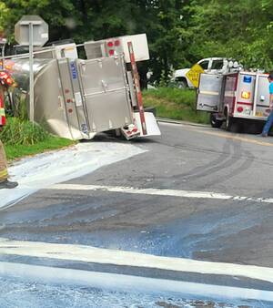 Carousel image 32b9080e3ba62f21c9f4 7 17 blot milk tank tractor trailer rolled onto side