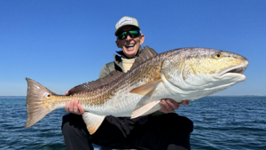 Carousel image ddf7e40fd6c2262a6ba4 adult holding large reddrum on motor vessel original