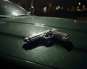 Carousel image c2d368aad1abbf6887ea bso vehicle nighttime with silver handgun on hood