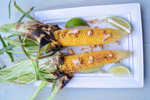 Carousel image clone 1090074 c69a318d53a56381c7dc carousel image a1d06c21c538648a763c behind the plates chili butter corn on the cob with lime