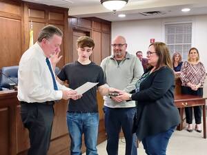 Carousel image 642f5b43530d8a38c565 chris condon is sworn in as a new hasbrouck heights firefighter by mayor kistner. his parents bill and lisa hold the bible