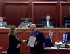 Carousel image 8041aa imberly utler from ging atters revard accepts proclamation from elbourne lorida ayor aul lfrey