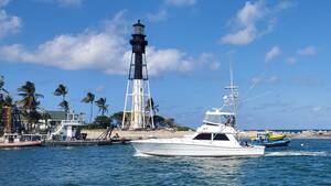 Carousel image 4e1af0281c100e61cf03 hillsboro inlet sand dredge with charter boat and lighthouse visible