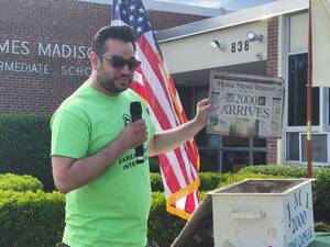 Carousel image c936343846aefdaa5f2f mayor sam joshi holding newspaper from jmi time capsule from 2000