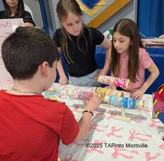 Carousel image 15b695b71a1923479cbe morgan salley and eleni tsakanias help a customer at their booth 2