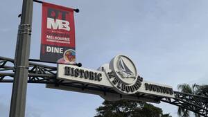 Carousel image 448afbe634ff2c232e4e red banner with downtown sign in background