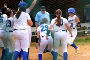 Carousel image 4df3c62e91552a02e9f0 scotch plains fanwood teammates greet sam friscia as she crosses home plate on a game changing home run. dsc05523