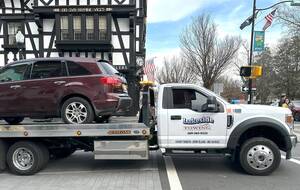 Carousel image 5cd11c983509140d43b8 tow truck and car on witherspoon