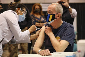 A masked Gov. Murphy was vaccinated earlier this year.