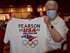 BASKING RIDGE, NJ - Beverly Siegler holds up a T-shirt for her grandson. Pearson is in the Olympic Triathlon.
