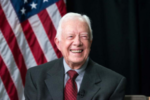 Carousel image d9a547e70bd6cb76e05f best crop 3ec6c4e608b011bc91e8 president jimmy carter flag bg