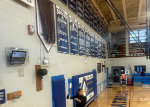 Carousel image 52a7283416f877528226 best crop a4da41fedb04fe42a1ad sydney mclaughlin levrone gets ready to unveil a 2024 olympic banner at union catholic honoring her accomplishments.